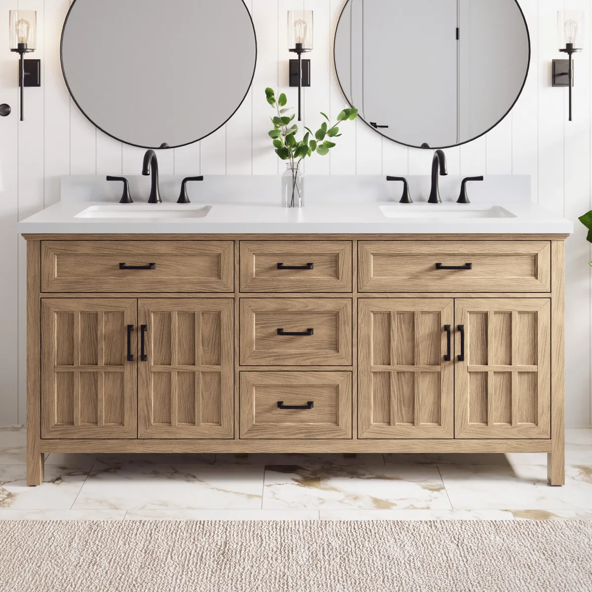Light oak double-sink vanity with a white quartz top, matte black widespread faucets and two round black-framed mirrors on white shiplap