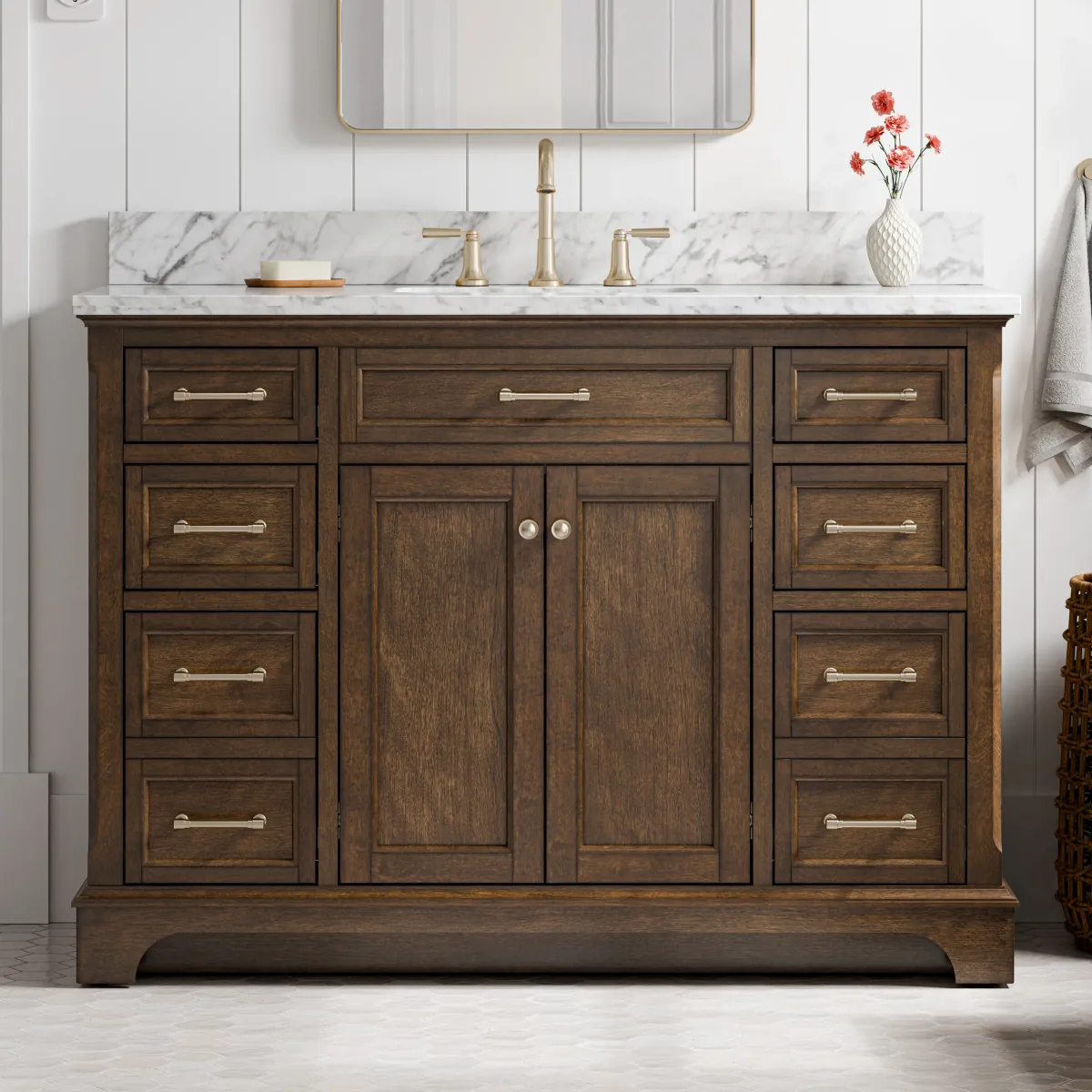 Dark walnut single-sink bathroom vanity with a white marble top, six drawers and brushed nickel bar pulls, against white shiplap