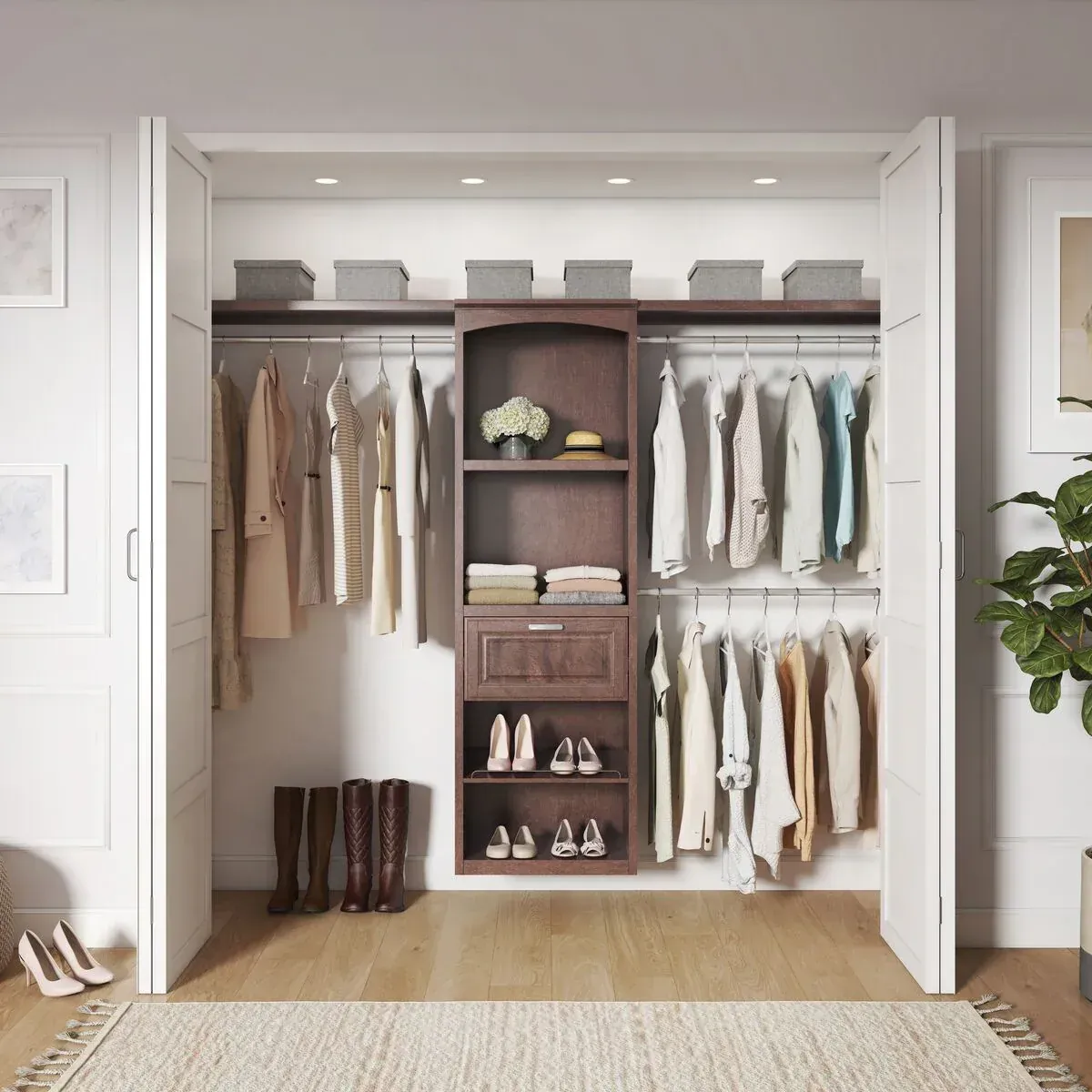 Fitted reach-in closet system with a dark wood tower, double hanging rails, adjustable shelves and storage bins
