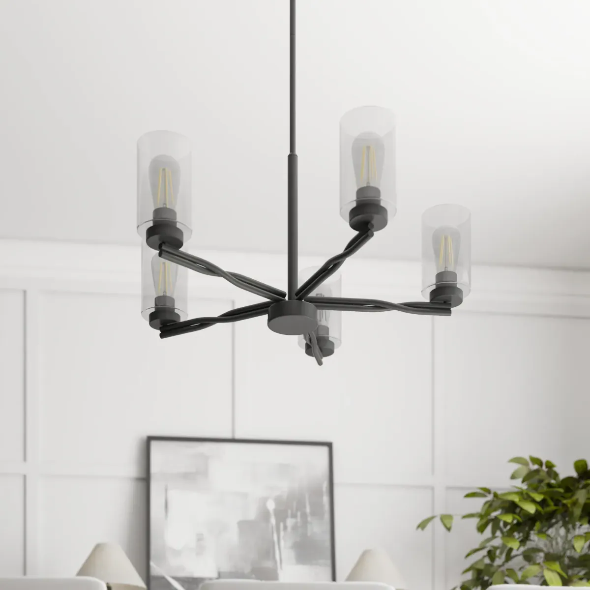Matte black five-light chandelier with clear glass cylinder shades and exposed filament bulbs above a dining table